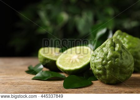 Fresh Ripe Bergamot Fruits With Green Leaves On Wooden Table Against Blurred Background, Space For T
