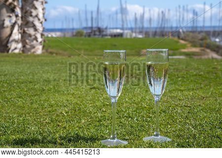 Celebration Of Championship With Glasses Of Champagne Bubbles Wine On Green Lawn Of Golf Club