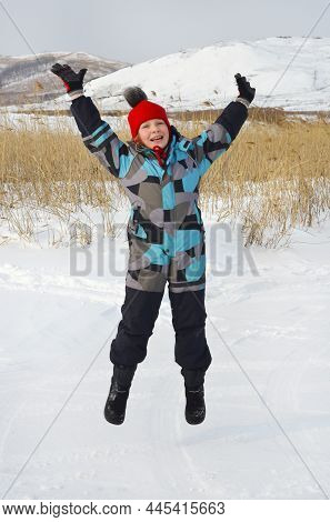 Caucasian Child In Winter Clothing Playing Outdoors