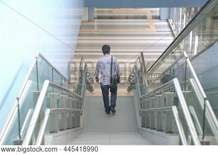 Man Going Down The Stairs Of A Modern Building. Going Home From Work Or Urban Living Concept.