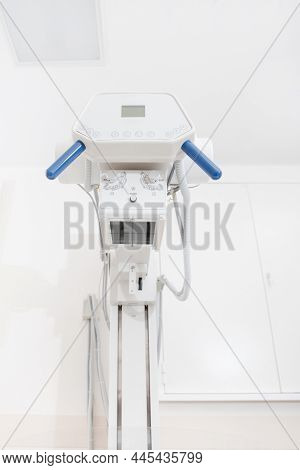 X-ray Department In Modern Hospital. Radiology Room With Scan Machine With Empty Bed. Technician Adj