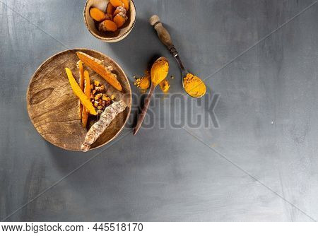 Healthy Curcuma Poweder And Roots On Grey Background .copy Space