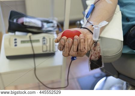 Bone Marrow Donation. Male Hand Holding Red Ball, Blood Transfusion System, Blood Bag.  Soft Focus