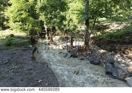 Dirty Stream Of A Mountain River After Rain And Mudflow With Soil Erosion. Landslides And Natural Di