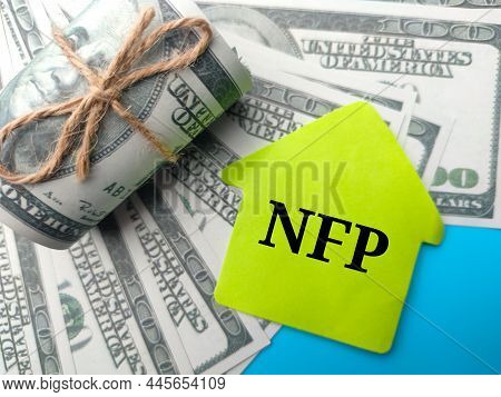 Banknotes And Colored Notepaper With Word Nfp On Blue Background.