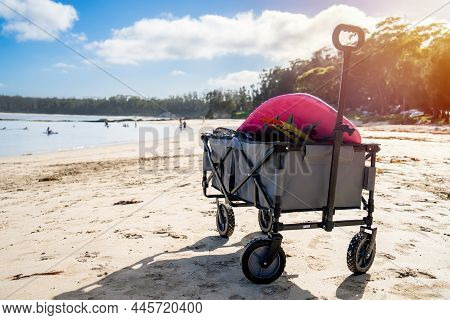 Outdoor Beach Cart Wagon On A Sandy Beach Near The Ocean. Family Vacation Holidays