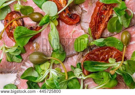 Vitello Tonato On A Plate On Dark Stone Table