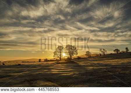 A Golden Sunrise Over Fields And Mountains Of The Brecon Beacons In South Wales Uk
