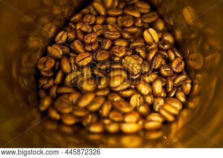 Roasted Aroma Whole Oval Coffee Beans On Metallic Jar For Sweet Morning And Delicious Drink For Chee