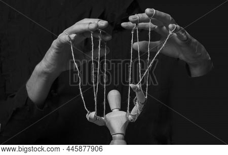 Hands Manipulating Puppet. Master Of Marionette In Action.