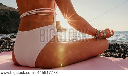 Middle Aged Well Looking Woman In White Swimsuit And Boho Style Braclets Practicing Outdoors On Yoga
