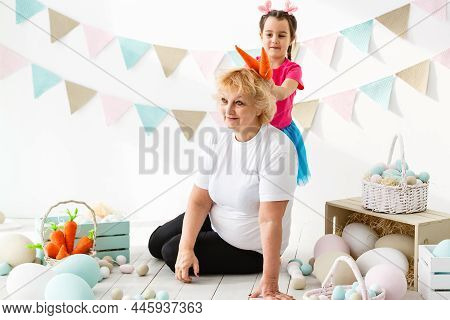 Easter Concept. Happy Llittle Girl And Grandmother With Easter Eggs
