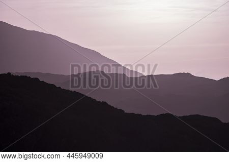 Beautiful Layered Mountain Landscape Image With Magenta Light At Sunrise