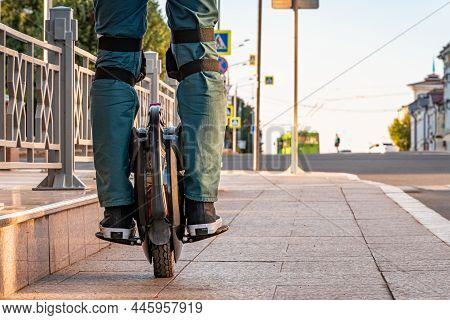 Rider\'s Legs In Protective Gear On An Electric Unicycle (euc). Driving Around The City On An Electr