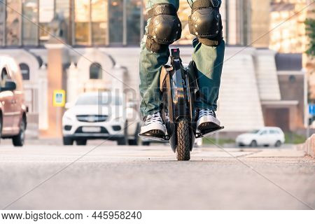 The Legs Of A Young Woman Ready To Ride An Electric Unicycle, Abbreviated Euc. An Unrecognizable Wom