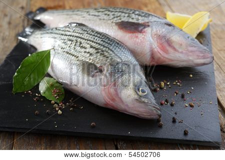 Raw sunshine bass with spices on a table