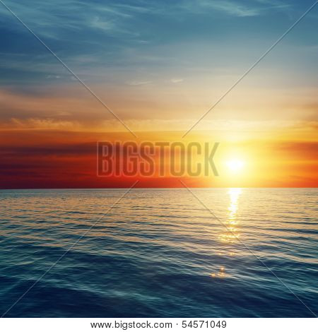 good red sunset over darken sea