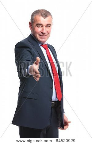 mid aged business man offering you his handshake with a smile on his face. isolated on a white background
