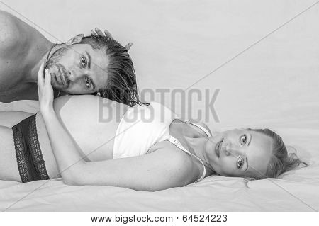 Man Listening To His Pregnant Wife's Belly