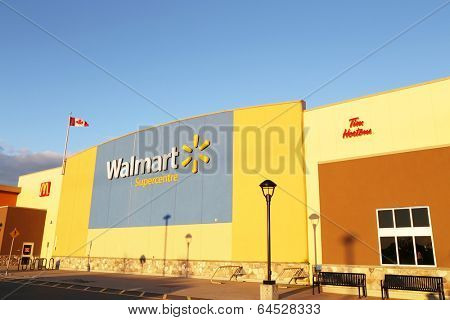 Port Coquitlam BC Canada - March 8, 2013 : Before sunset view of Walmart exterior. Walmart runs large discount stores and is the world's largest public corporation.  