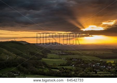 Stunning Vibrant Summer Sunset Over Escarpemt Landscape