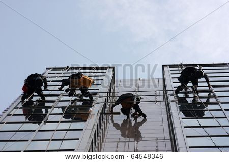 Men cleaning windows on a corporate bouilding