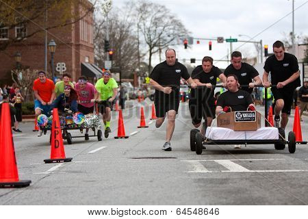 Two Teams Race Beds On City Street