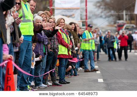 Spectators Cheer Oncoming Participants In Small Town Race