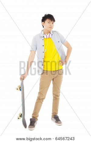 Funky Young Man Standing And Holding A Skateboard
