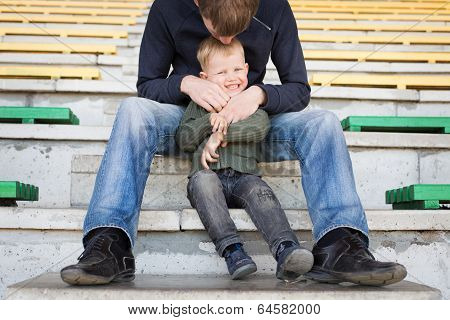 Father and son playing in empty stadium