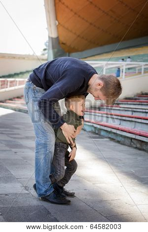 Father and son playing in empty stadium