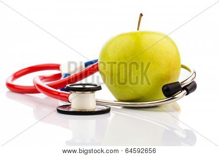 an apple and a stethoscope on a doctor. symbolic photo for healthy and vitamin-rich diet.