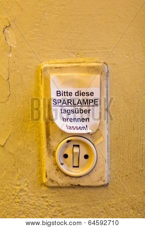 old light switch with label, let it burn saving lamp daytime