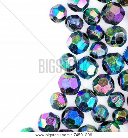 Macro Of Facted Shiny Metallic Beads Against White