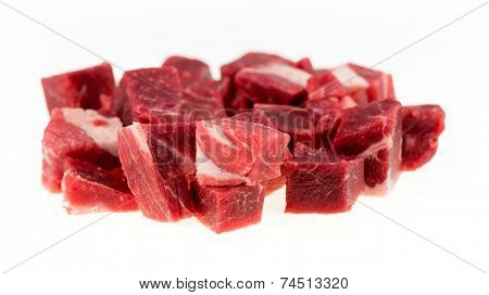 Macro Of Diced Chunks Of Raw Lamb And Mutton Meat Isolated On White