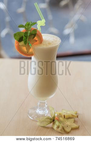 Milk cocktail with orange and carom