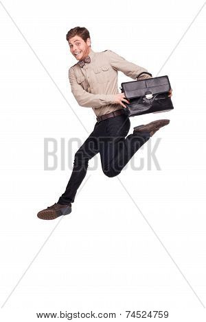 Smiling businessman jumping with briefcase