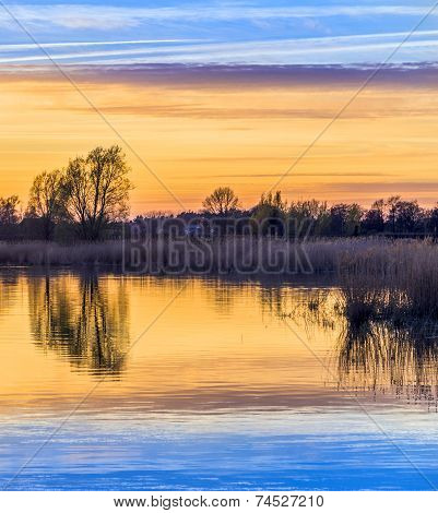 Sunset In Zinnowitz With Reflection On The Water