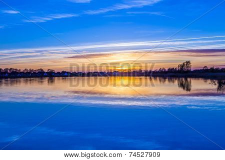 Sunset In Zinnowitz With Reflection On The Water