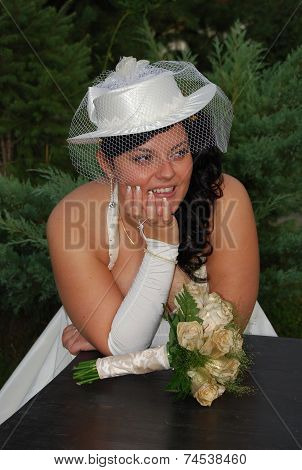 Young brunette overweight bride posing for the camera outdoors