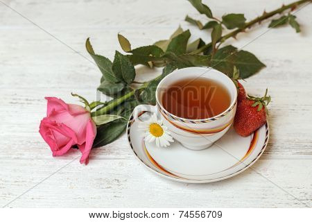 Cup Of Tea On The Table With Rose And Strawberries