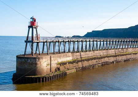 Scenic view of Whitby Pier in sunny autumn day, UK