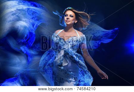 Young pregnant woman in fashionable dress