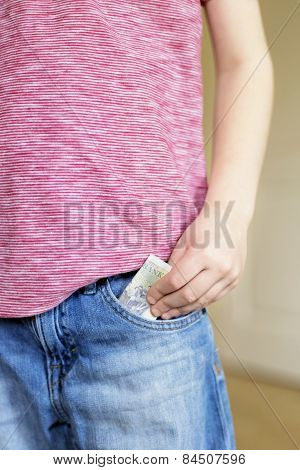 Boy Puts Cash Bank Note Into Pocket