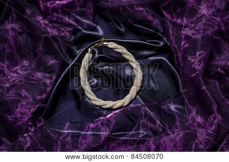 Gold Necklace On A Silk Background