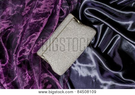 White Clutch Inlaid Diamonds On Silk Background