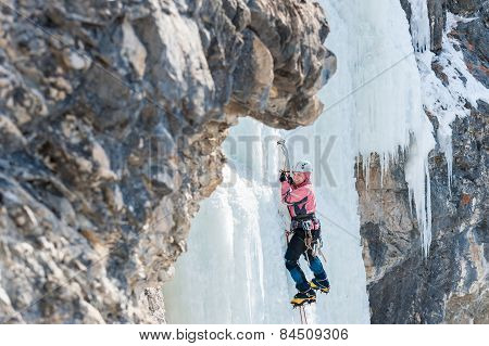 Woman Mountaineer Climbs On Vertical Icefall