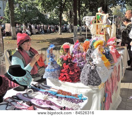 Street Stand Saleswoman Of Souvenir Dolls