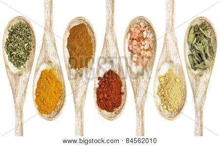 healthy seasoning and spices - a collection of isolated wooded spoons