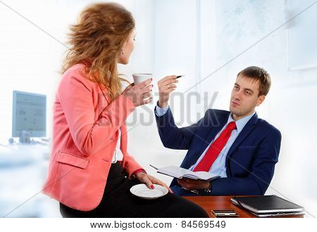 Head and secretary talking in the office.
